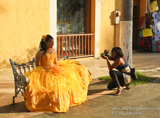 a mexican girl gets photos for her sweet 15, her quinceanera on the streets of Veracruz, Mexico