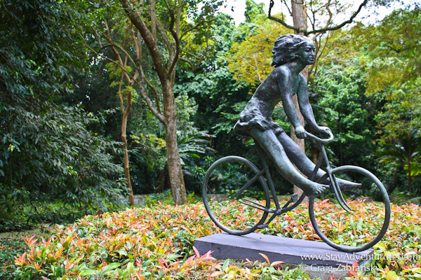 girl on bicycle sculpture inside the botanic garden in singapore