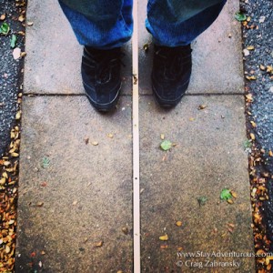 standing in the east and west, both sides of 0 longitude, the Prime Meridian in Greenwich, London, UK