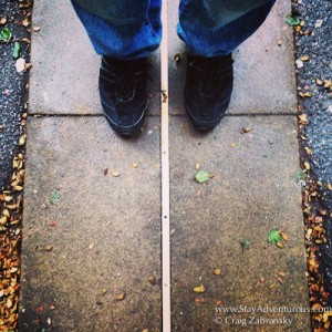 standing in the east and west, both sides of 0 longitude, the Prime Meridian in Greenwich, London, UK