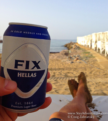 relaxing on the island of Crete at the Knossos Beach Bungalows with a look Greek Fix beer