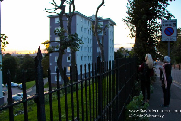 fellow onlookers enjoying a british treat, the london skyline at sunset