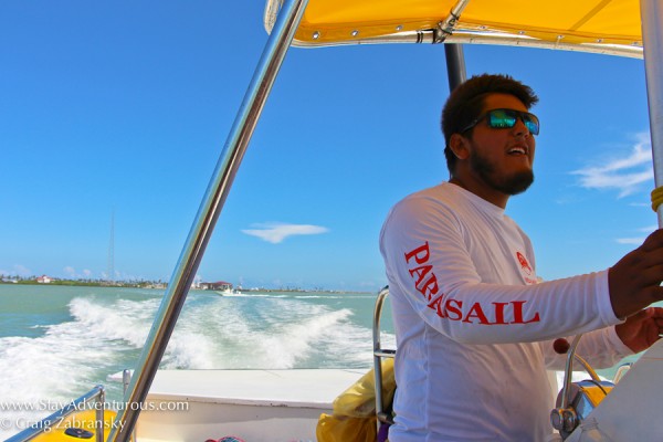 parasail of brekaway cruises captain guides the boat in south padre island, texas