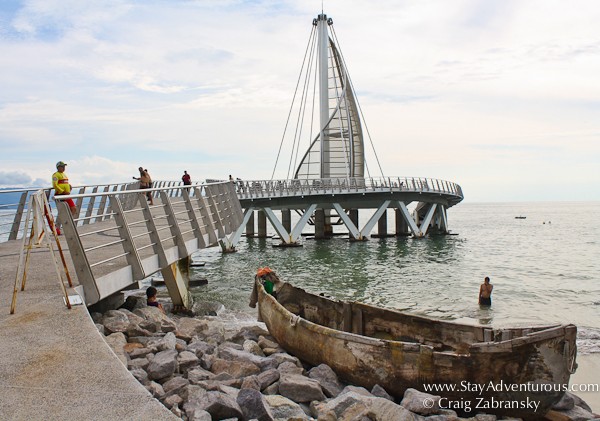 an old boat next to the new los muertos pier