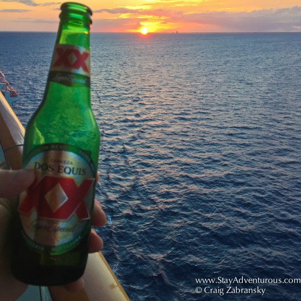 sunset cerveza on the balcony of my state onboard the NCL Getaway in the Caribbean 