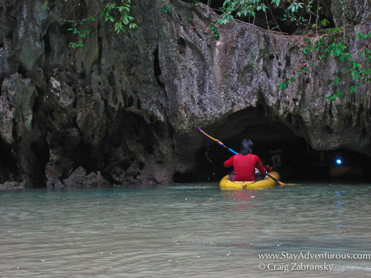 entering a cave in a sea kayak in Thailand