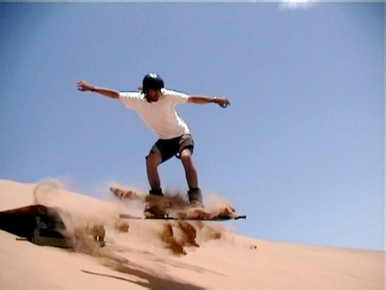 sand boarding on the desert sands of dubai in the middle east