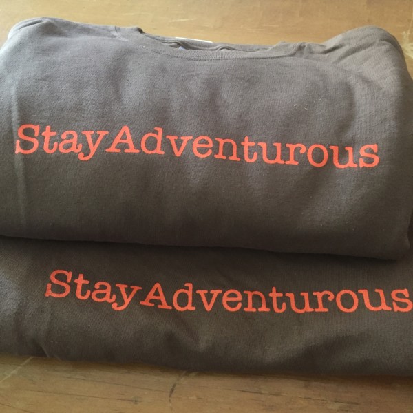 stay adventurous t-shirts by CreateAShirt in Orange Bach, AL