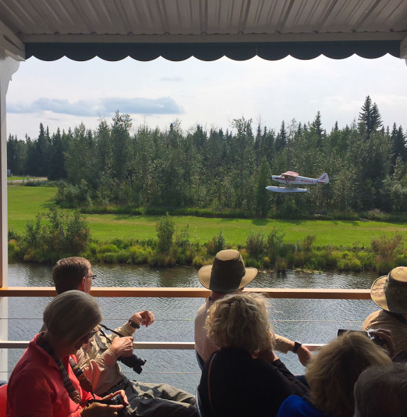 the bush pilot in a seaplane takes off on the chena river from the Riverboat Tour on the Discovery III in Fairbanks, AK