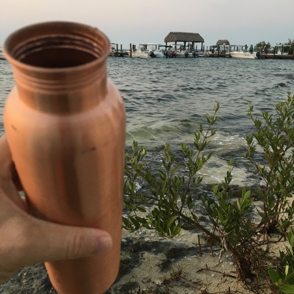 taking a sip by the sea out of my copper h20 water bottle