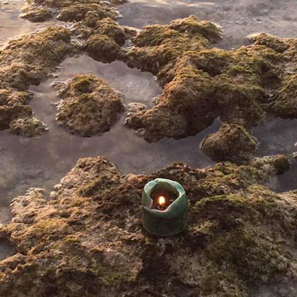 candle burns brightly during sunset in islamorada