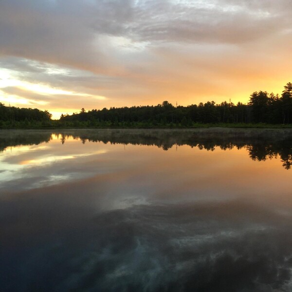 A summer sunrise at Little Teedyuskung Lake at the Lodge at Woodloch