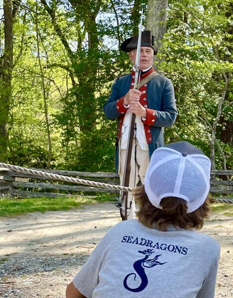 continental army soldier prepares to shoot a musket at the American Revolution Museum of Yorktown, Virginia