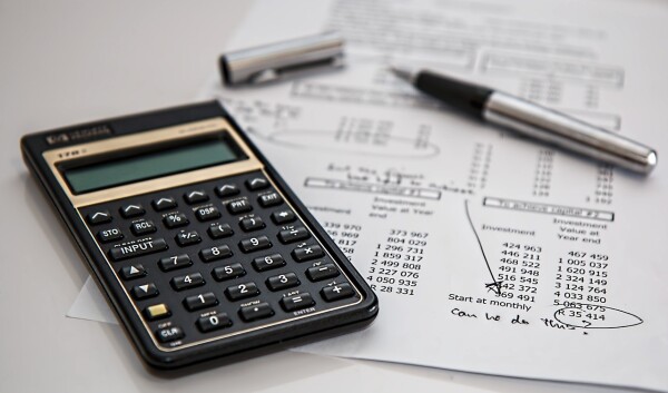 accounting and bookkeeping with calculator and pen