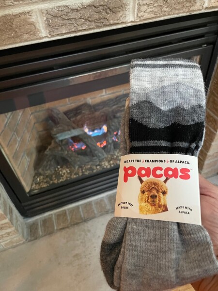 comfy and cozy pacas socks by a fireplace