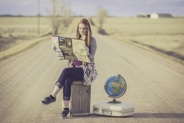 girl with map, globe, on the road - a traveller