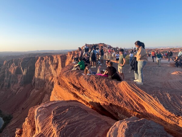 crowds taking in the sunset at horseshoe bend arizona